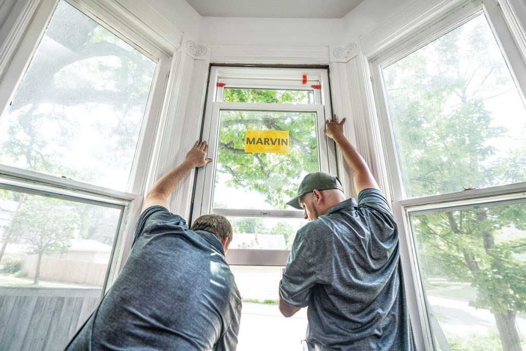 Technician installing energy-efficient window