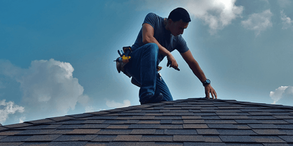 Roofing contractor inspecting a residential roof in South Georgia